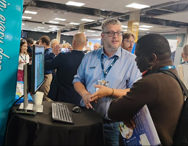 Simon talking to a GIS professional at an event