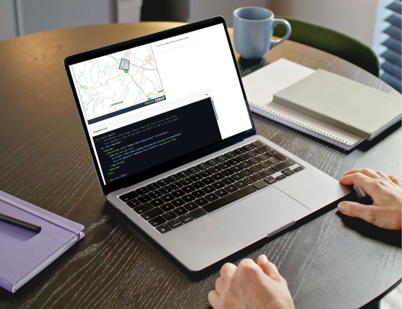Laptop showing code and an example interactive map. The person hasn't done anything, it's just our sample code!