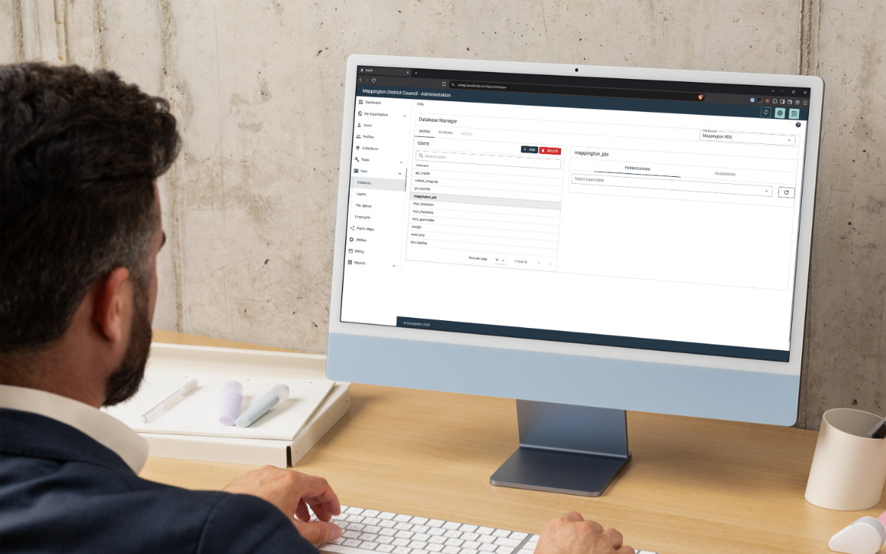 bloke on a desktop computer using XMAP Admin Panel to administer a cloud database. It looks like a Mac but isn't